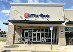 The front of Little Greek Fresh Grill in Tarpon Springs, with Little Greek signage over the glass entrance.